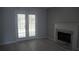 Cozy living room area featuring a fireplace and access to the backyard via patio doors at 6460 Wellington Chase Ct, Lithonia, GA 30058