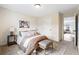 Cozy bedroom with a comfortable bed, stylish bench, and neutral decor at 208 Starr Cir, Stockbridge, GA 30281