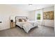 Bedroom featuring a comfortable bed, carpet, and a bright window at 208 Starr Cir, Stockbridge, GA 30281