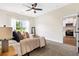 A bedroom with neutral tones, carpet, and a kitchen visible through the door at 208 Starr Cir, Stockbridge, GA 30281