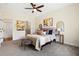 A bedroom with neutral tones, carpet, a ceiling fan, and decorative accents at 208 Starr Cir, Stockbridge, GA 30281