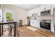 Modern kitchen featuring stainless steel appliances, white cabinets, and hardwood floors at 208 Starr Cir, Stockbridge, GA 30281