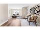 A living room with hardwood floors, neutral-toned furniture, artwork, and natural lighting at 208 Starr Cir, Stockbridge, GA 30281