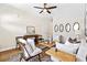 Cozy living room featuring hardwood floors, neutral tones, and modern ceiling fan at 208 Starr Cir, Stockbridge, GA 30281