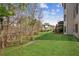 Large, grassy backyard with mature trees providing shade and privacy, and a clear view of the deck at 3915 Northridge Dr, Cumming, GA 30040
