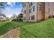 Expansive backyard featuring lush green grass and the home's exterior with a deck and brick facade at 3915 Northridge Dr, Cumming, GA 30040