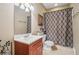 Bathroom featuring a vanity with wood cabinets and shower/tub combo with decorative shower curtain at 3915 Northridge Dr, Cumming, GA 30040