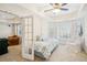 Comfortable bedroom featuring carpet floors, natural light, and an adjacent living space at 3915 Northridge Dr, Cumming, GA 30040