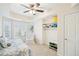 Cozy bedroom featuring a ceiling fan and a bright window with natural light and built-in shelves for storage at 3915 Northridge Dr, Cumming, GA 30040