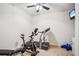 Well-equipped exercise room with treadmill, stationary bike, weight bench and wall-mounted TV for convenience at 3915 Northridge Dr, Cumming, GA 30040