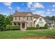 Charming two-story home with brick and siding exterior, lush landscaping, and a well-manicured lawn at 3915 Northridge Dr, Cumming, GA 30040