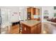 Open concept kitchen featuring an island with seating and seamless flow to living area with fireplace at 3915 Northridge Dr, Cumming, GA 30040