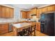 Kitchen featuring wooden cabinets, black appliances, and an island at 3915 Northridge Dr, Cumming, GA 30040