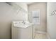 Efficient laundry room with white washer and dryer, wire shelving and window for ventilation at 3915 Northridge Dr, Cumming, GA 30040
