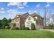 Two-story home with brick and siding exterior, green lawn and manicured landscaping at 3915 Northridge Dr, Cumming, GA 30040