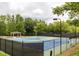 Scenic tennis courts with lighting and gazebo surrounded by lush greenery for recreation and relaxation at 3915 Northridge Dr, Cumming, GA 30040