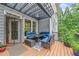 Comfortable seating area on the back deck provides an inviting place to unwind and enjoy outdoor living at 420 Big Bend Trl, Sugar Hill, GA 30518