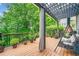 View of the back deck with a cozy swing and a peaceful backdrop, ideal for relaxation and enjoying the outdoors at 420 Big Bend Trl, Sugar Hill, GA 30518