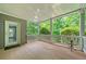 Covered back porch with wooden deck and white railings, overlooking lush greenery at 420 Big Bend Trl, Sugar Hill, GA 30518