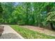 Manicured lawn and landscaping in the backyard enhance the home's curb appeal and outdoor enjoyment at 420 Big Bend Trl, Sugar Hill, GA 30518