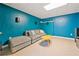 Finished basement with a sectional sofa, accent wall and carpeted floor at 420 Big Bend Trl, Sugar Hill, GA 30518