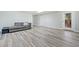 Finished basement featuring gray wood-look flooring, a seating area, and a walkout door at 420 Big Bend Trl, Sugar Hill, GA 30518