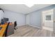 Finished basement with gray wood-look flooring and a home office setup at 420 Big Bend Trl, Sugar Hill, GA 30518