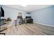 Finished basement with gray wood-look flooring and a home office setup at 420 Big Bend Trl, Sugar Hill, GA 30518