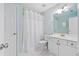 Bright bathroom featuring a white vanity, toilet, and shower with a white shower curtain at 420 Big Bend Trl, Sugar Hill, GA 30518