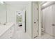 Bright bathroom featuring white cabinets, with access to a shower and relaxing bedroom at 420 Big Bend Trl, Sugar Hill, GA 30518