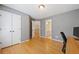 A bright bedroom with hardwood floors, closet, and attached bathroom access, perfect for flexible living at 420 Big Bend Trl, Sugar Hill, GA 30518