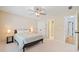 A bright bedroom illuminated by stylish lamps, leading to an attached bathroom and views of the upper floors at 420 Big Bend Trl, Sugar Hill, GA 30518