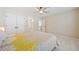 A spacious bedroom featuring bright yellow accents, leading to an attached bathroom and an entrance to the upper floor at 420 Big Bend Trl, Sugar Hill, GA 30518