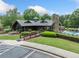 Community clubhouse with charming architectural design and manicured landscaping and pool in background at 420 Big Bend Trl, Sugar Hill, GA 30518