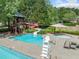 Community pool area complete with water slide, hot tub, and lounge chairs for relaxing by the water at 420 Big Bend Trl, Sugar Hill, GA 30518