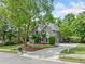 Attractive house with manicured lawn, mature trees, and long driveway at 420 Big Bend Trl, Sugar Hill, GA 30518