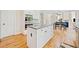 Open kitchen flows into the living space, featuring a center island and hardwood floors at 420 Big Bend Trl, Sugar Hill, GA 30518
