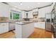 Bright kitchen with stainless steel appliances, granite countertops, and center island at 420 Big Bend Trl, Sugar Hill, GA 30518