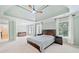 Spacious main bedroom features a trey ceiling, ceiling fan, and two windows for lots of natural light at 420 Big Bend Trl, Sugar Hill, GA 30518