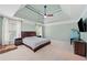 This is a spacious main bedroom with a ceiling fan and TV at 420 Big Bend Trl, Sugar Hill, GA 30518