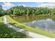 Picturesque view of the pond, green trees, grass and footpath, a beautiful natural area at 420 Big Bend Trl, Sugar Hill, GA 30518