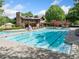 A sparkling community pool with a beautiful stone and wood clubhouse and ample lounging space at 420 Big Bend Trl, Sugar Hill, GA 30518