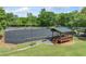 View of the community tennis court with a covered seating area for players and viewers at 420 Big Bend Trl, Sugar Hill, GA 30518
