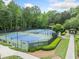 Well-maintained community tennis courts with shaded seating areas and attractive landscaping at 420 Big Bend Trl, Sugar Hill, GA 30518