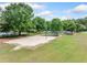 A sand volleyball court adjacent to a playground and other recreational areas in the community at 420 Big Bend Trl, Sugar Hill, GA 30518