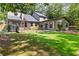 Lush backyard featuring a deck, seating area and a large lawn perfect for outdoor activities at 4531 Kings Lake Dr, Marietta, GA 30067