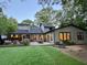 Spacious backyard with lush green grass, outdoor seating area, and mature trees at 4531 Kings Lake Dr, Marietta, GA 30067