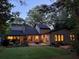 Backyard featuring a patio, outdoor seating, and well-maintained lawn with mature trees at 4531 Kings Lake Dr, Marietta, GA 30067
