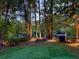 Expansive backyard with a lush lawn, fenced perimeter, and wooded views at 4531 Kings Lake Dr, Marietta, GA 30067