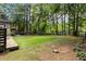 A lush backyard with mature trees, a lawn, and a glimpse of the lake at 4531 Kings Lake Dr, Marietta, GA 30067